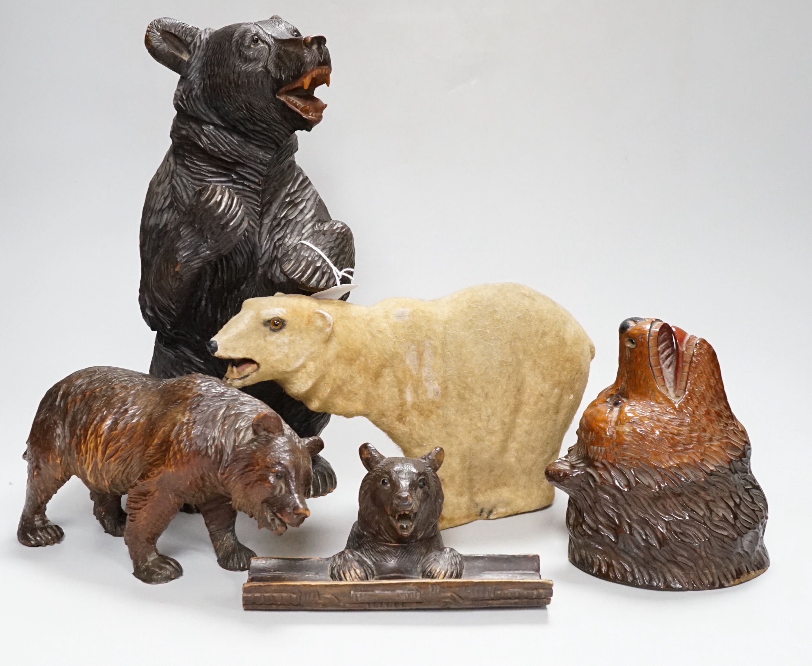 A group of Black Forest wooden carved bears, one standing 13in., with a barometer, 8in., and twelve smaller bears